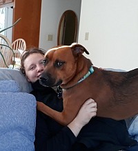 A woman with a dog on her lap