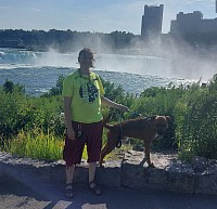 Woman and dog in front of Niagara falls